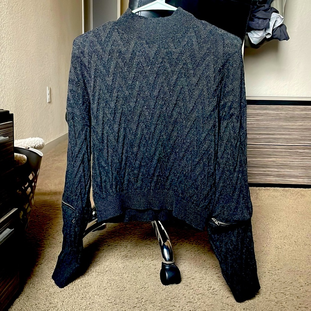 This is a light weight sweatshirt piece. It has zipper sleeves.
